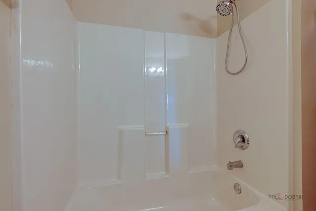 a view of a livingroom with a ceiling fan and window