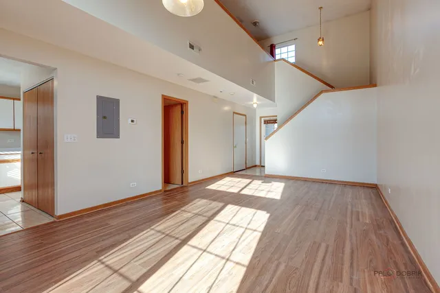 a view of empty room with wooden floor