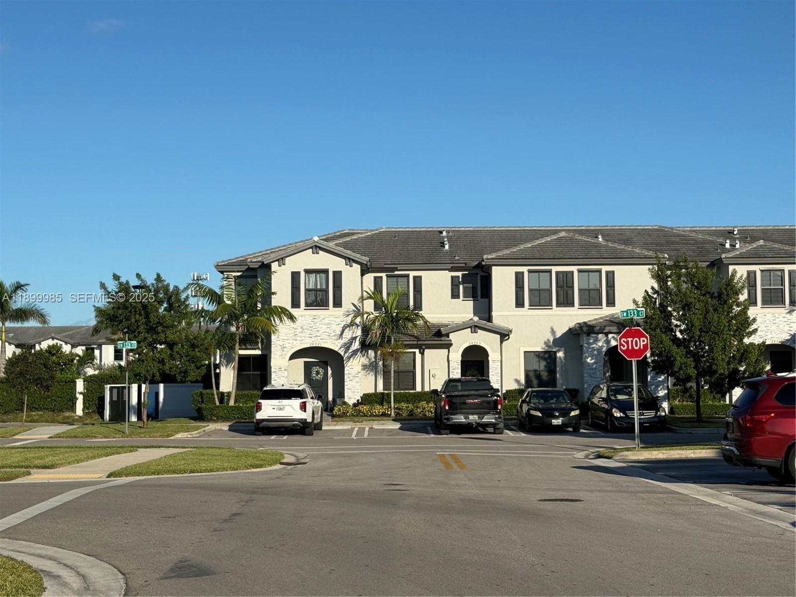 13322 Southwest 287th Terrace Homestead, FL 33033 - Photo 2 of 9 a white house that has a street sign on the side of it