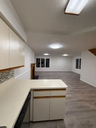 a kitchen with stainless steel appliances granite countertop a sink and a stove