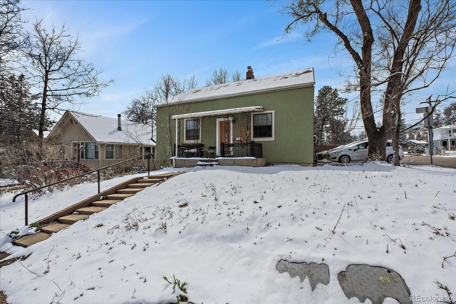2002 Baseline Road Boulder, CO 80302 - Photo 2 of 31 a front view of a house with a yard covered with snow