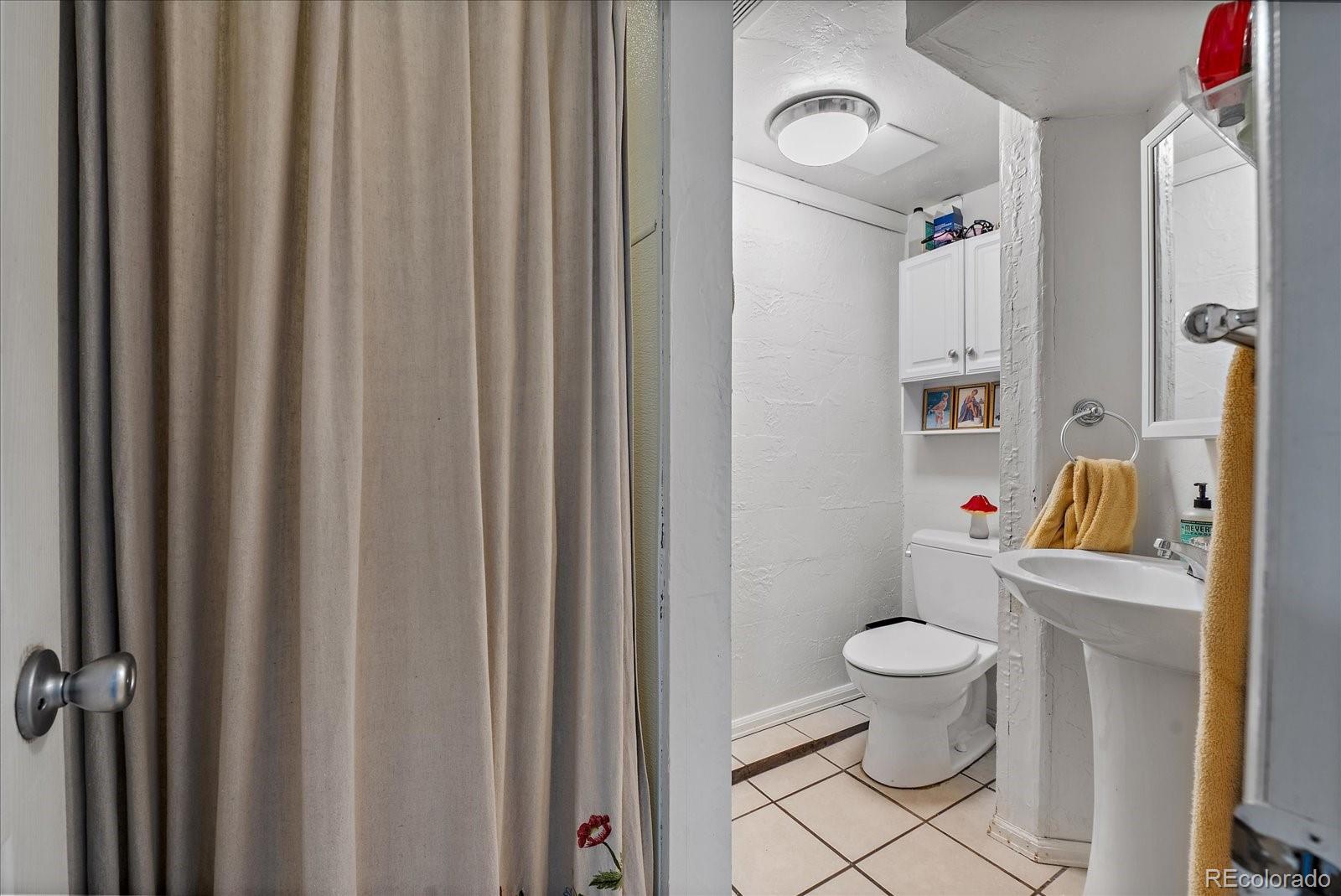 2002 Baseline Road Boulder, CO 80302 - Photo 26 of 31 a bathroom with a toilet and a shower curtain