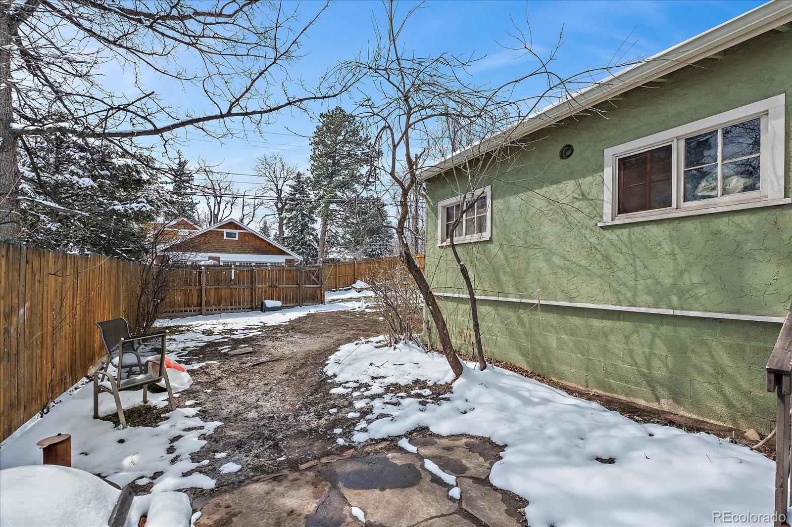 2002 Baseline Road Boulder, CO 80302 - Photo 27 of 31 a backyard of a house with table and chairs under an umbrella