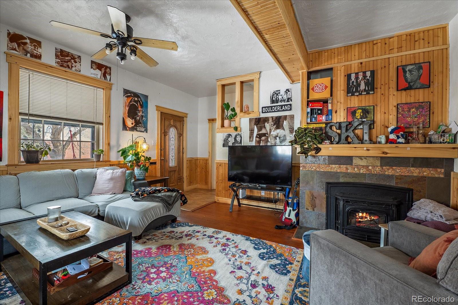 2002 Baseline Road Boulder, CO 80302 - Photo 6 of 31 a living room with furniture a flat screen tv and a fireplace