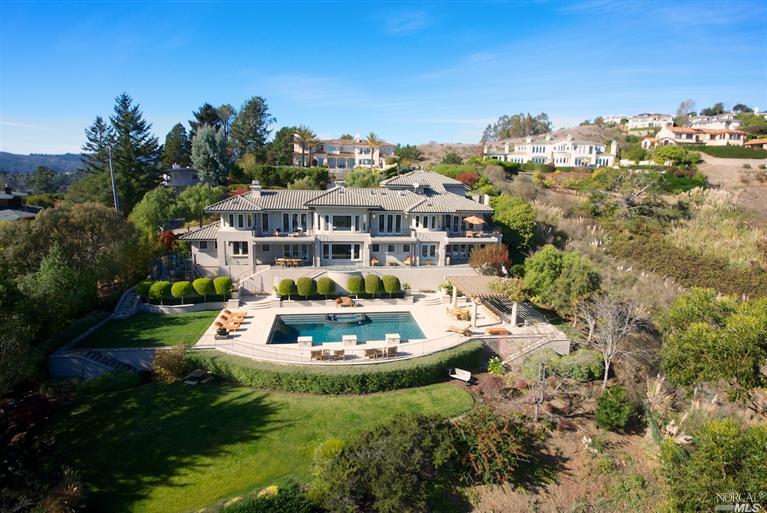 a front view of a house with yard swimming pool and outdoor seating