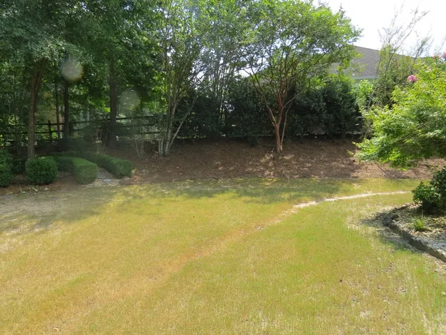 a view of a yard with swimming pool