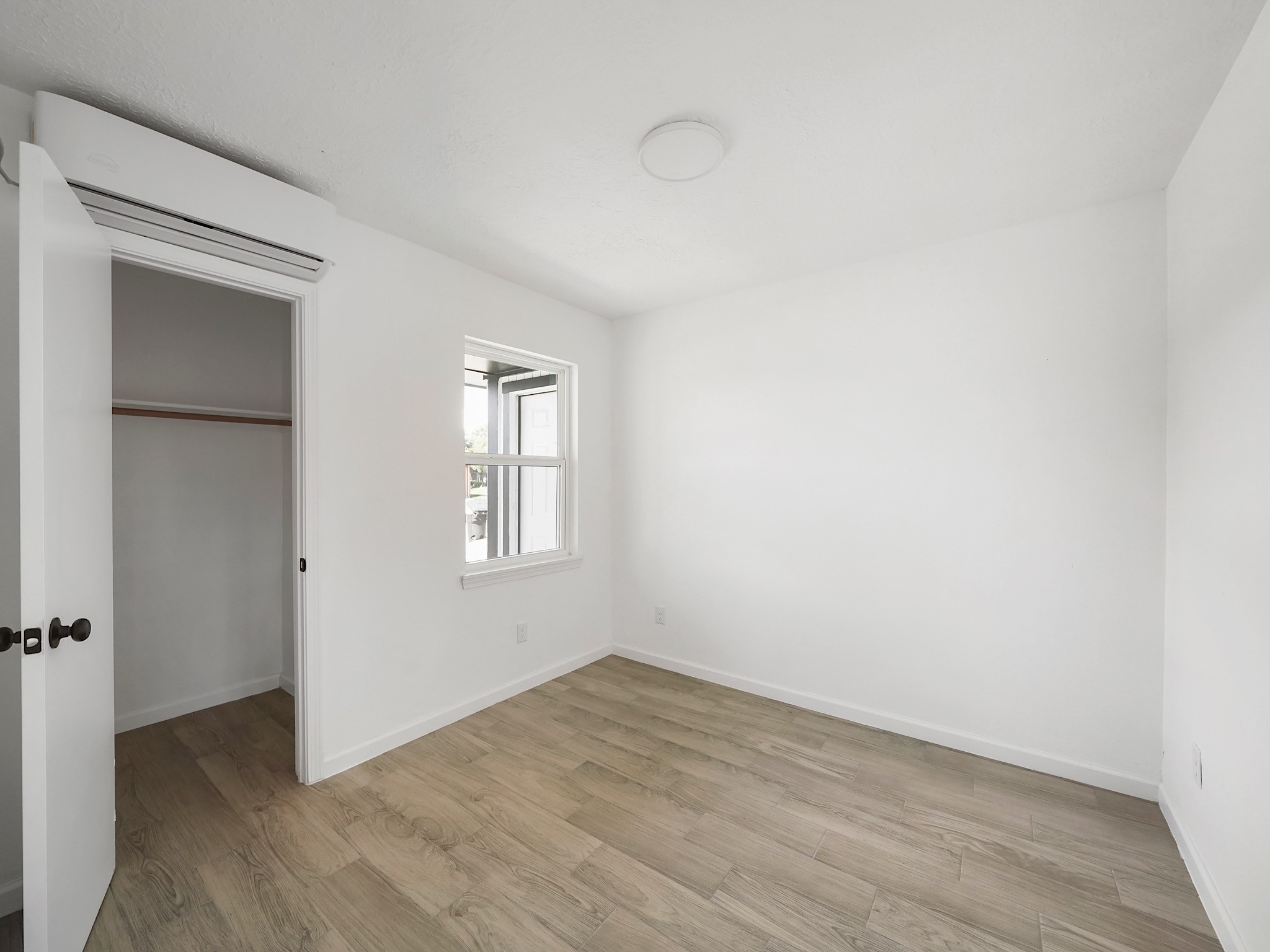 3607 Marchant Road Houston, TX 77047 - Photo 12 of 18 an empty room with wooden floor and windows