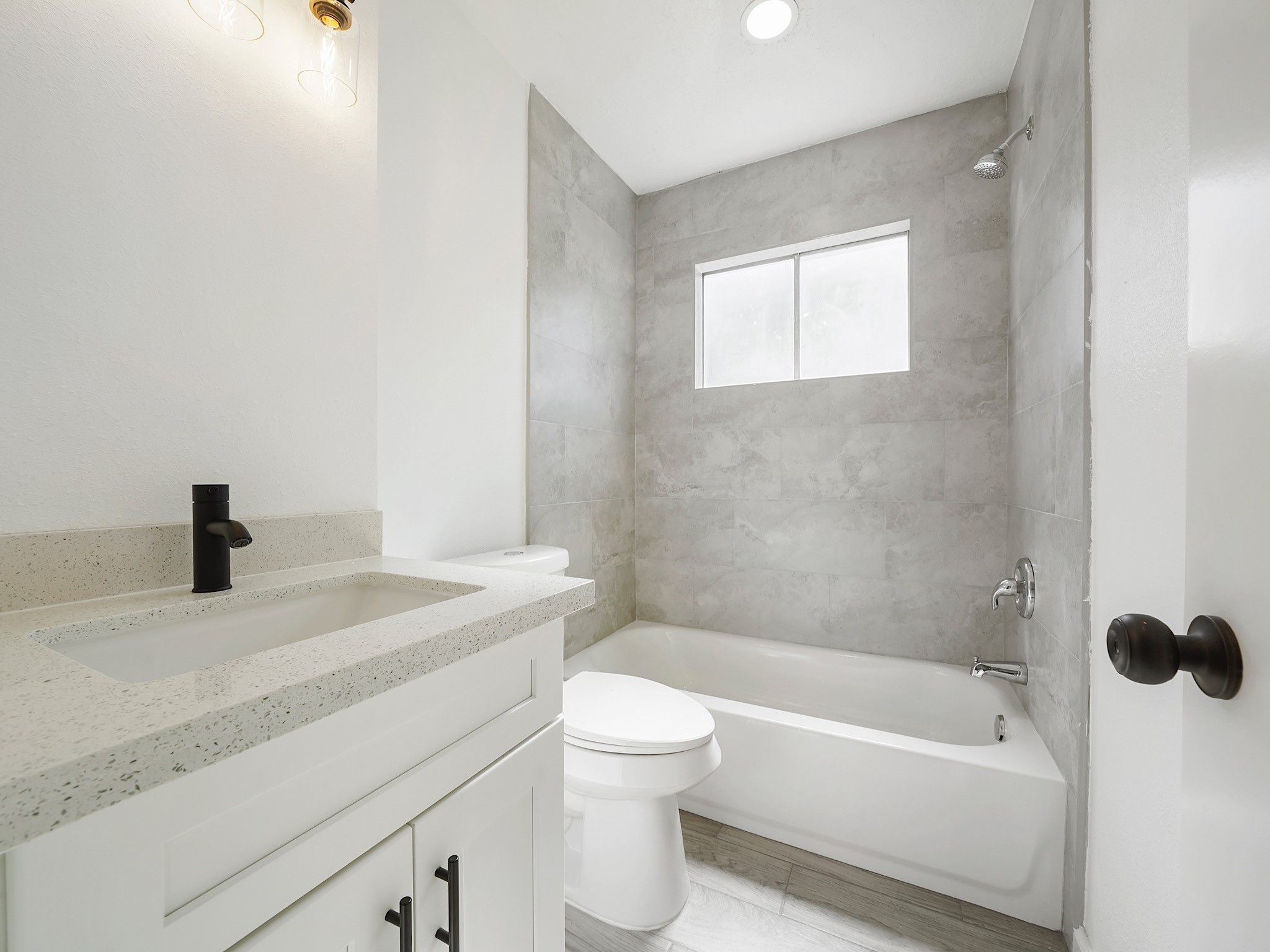 3607 Marchant Road Houston, TX 77047 - Photo 13 of 18 a bathroom with a granite countertop sink toilet a bathtub and a shower
