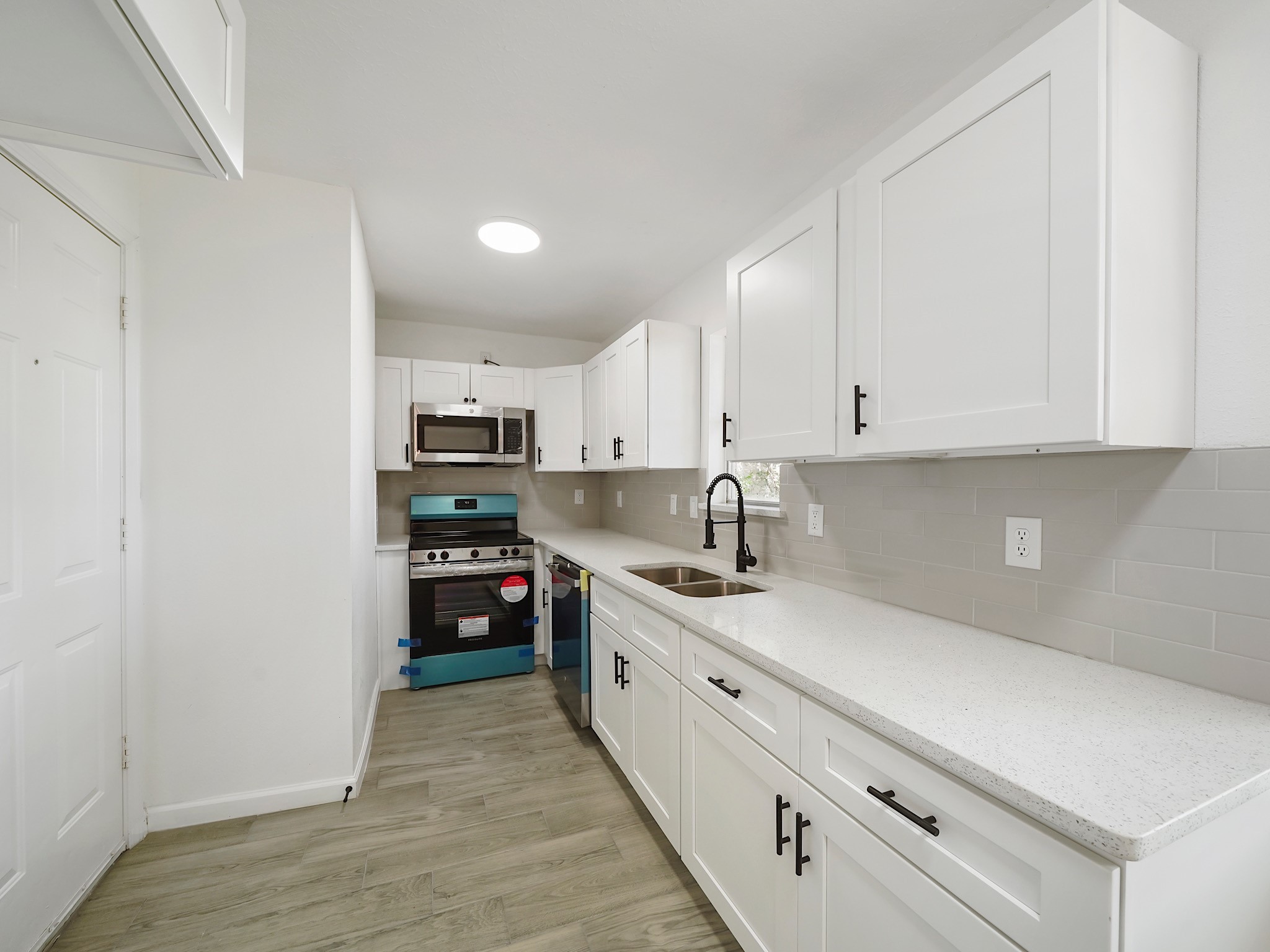 3607 Marchant Road Houston, TX 77047 - Photo 17 of 18 a kitchen with stainless steel appliances granite countertop a stove a sink and a refrigerator
