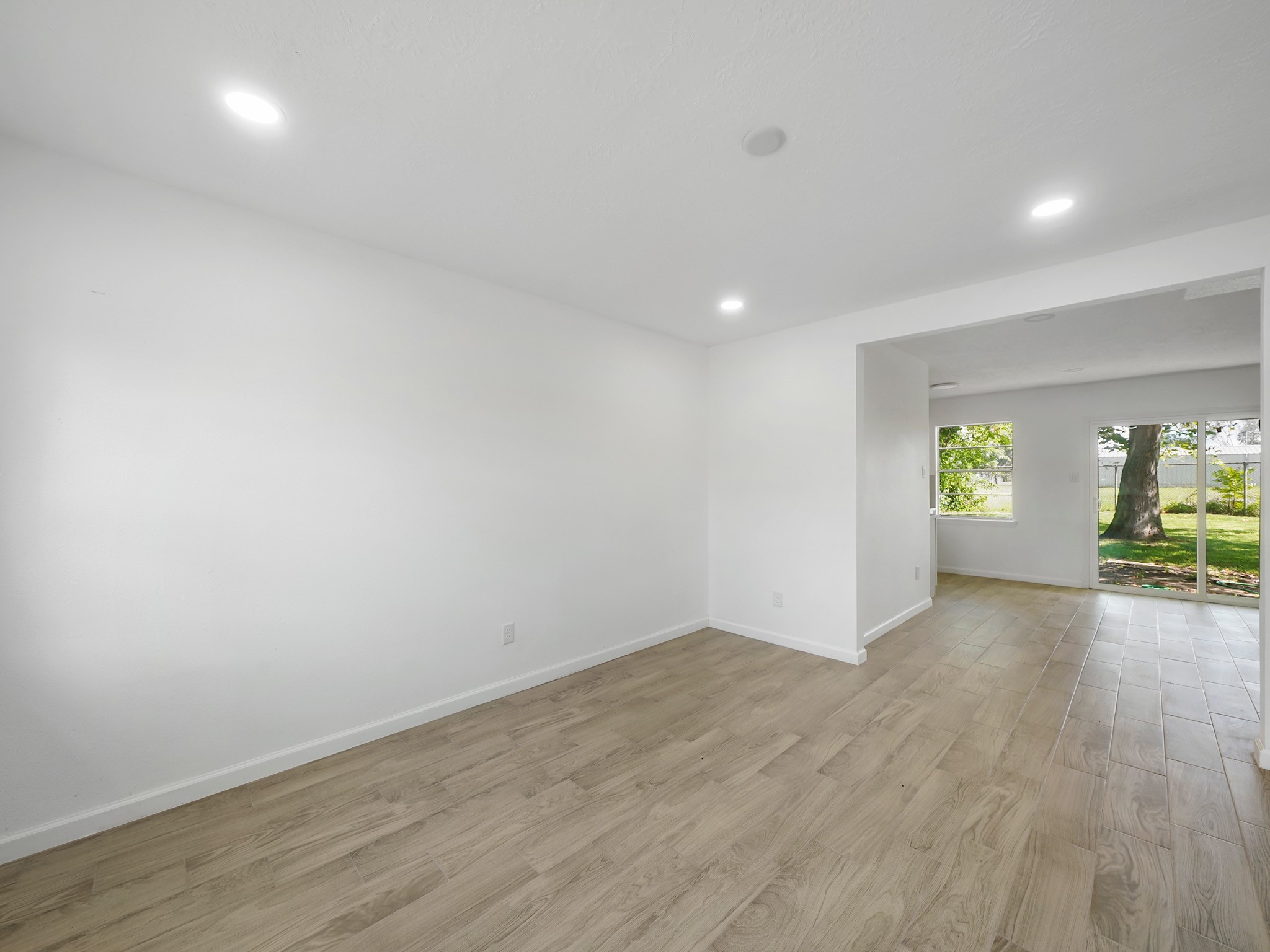 3607 Marchant Road Houston, TX 77047 - Photo 3 of 18 wooden floor in an empty room with a window