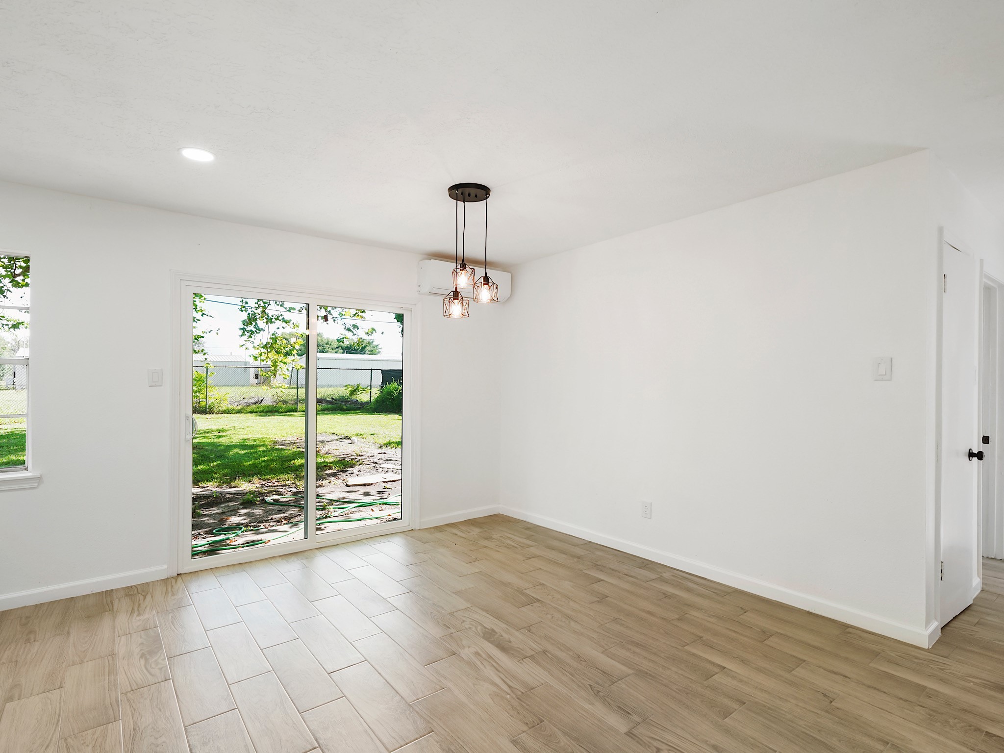 3607 Marchant Road Houston, TX 77047 - Photo 6 of 18 a view of an empty room with wooden floor and a window