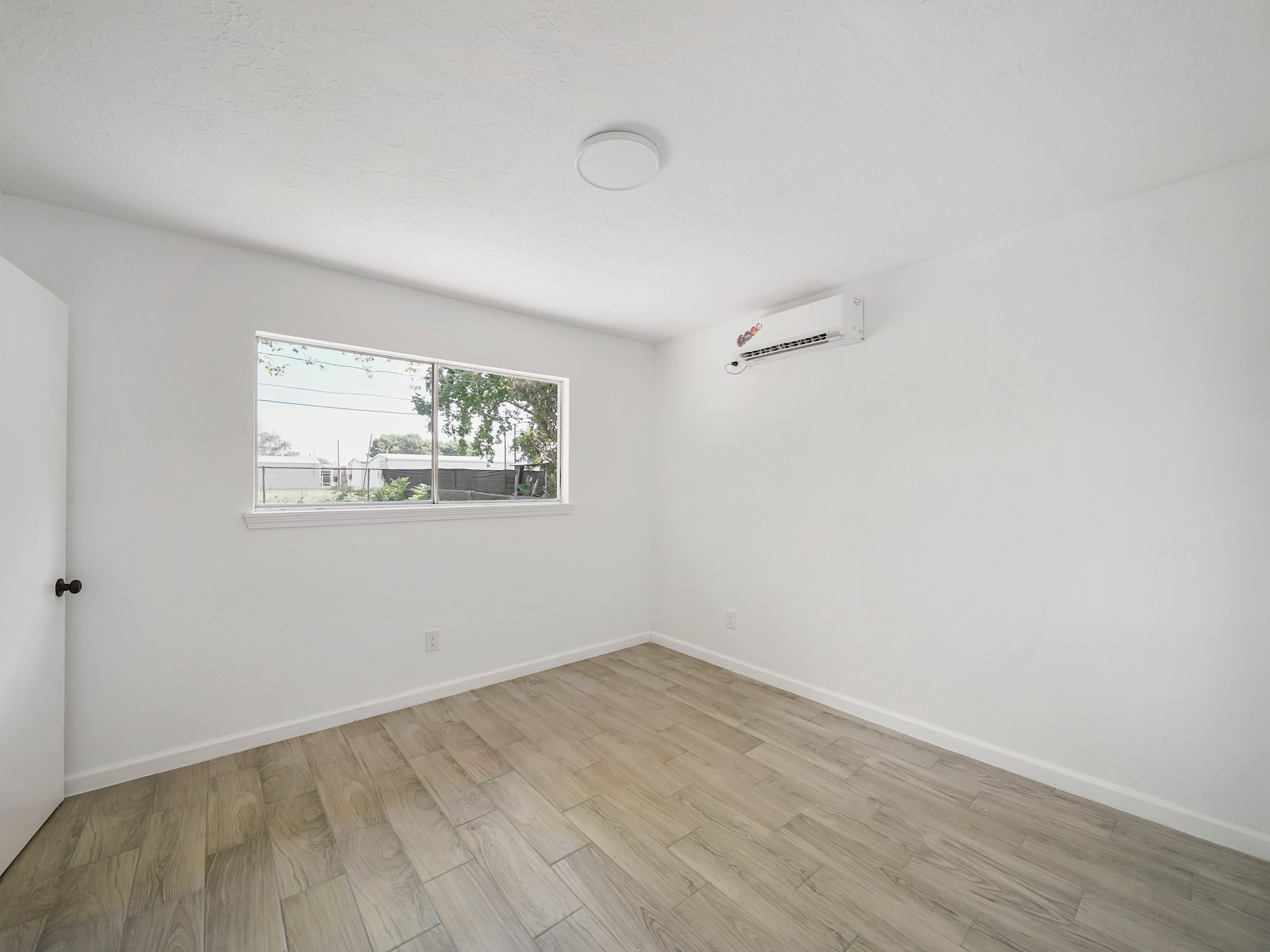 3607 Marchant Road Houston, TX 77047 - Photo 10 of 18 an empty room with wooden floor and windows