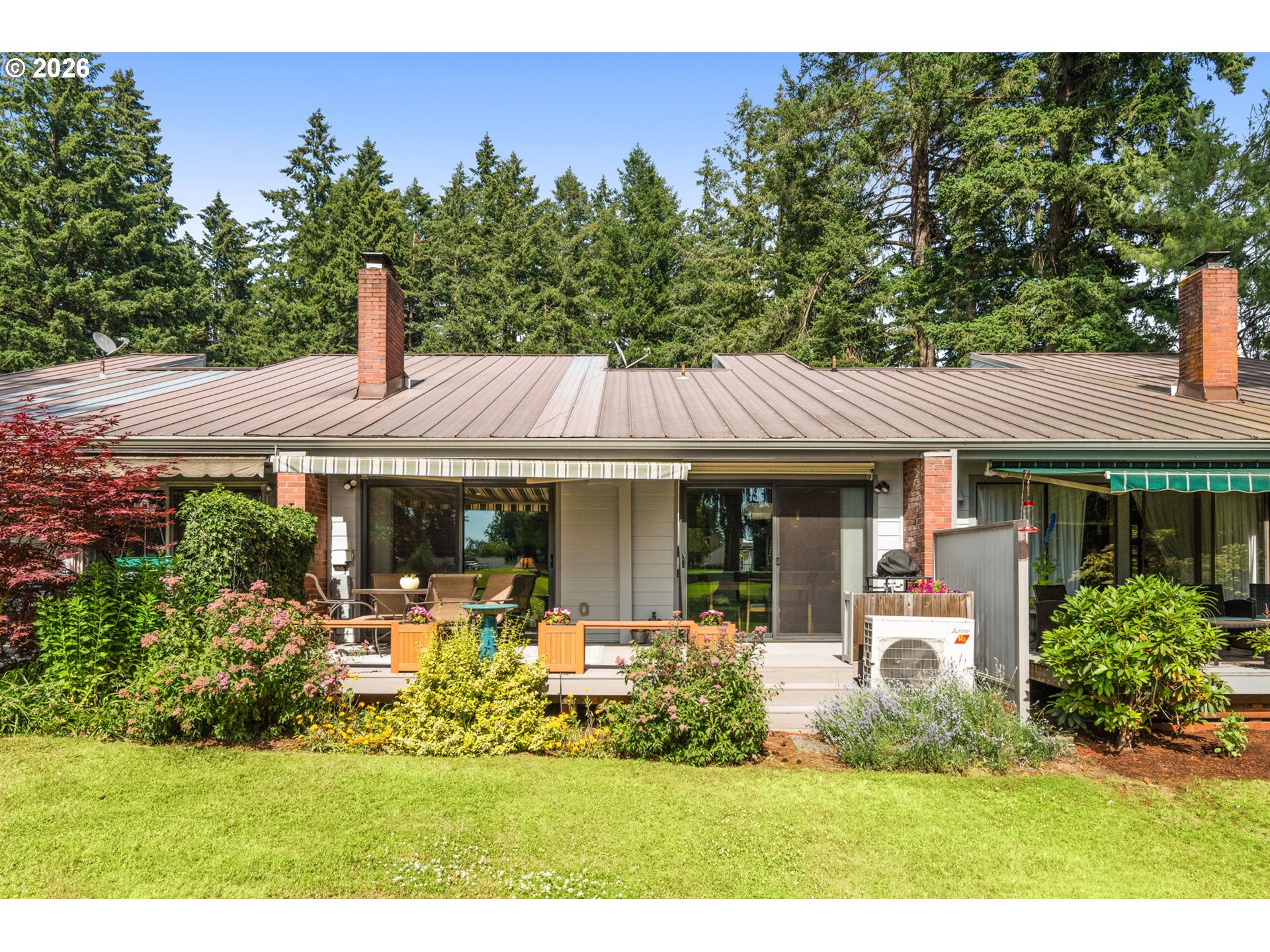 1200 Northeast Territorial Road, Unit 12 Canby, OR 97013 - Photo 19 of 38 a view of a patio with table and chairs potted plants and large tree