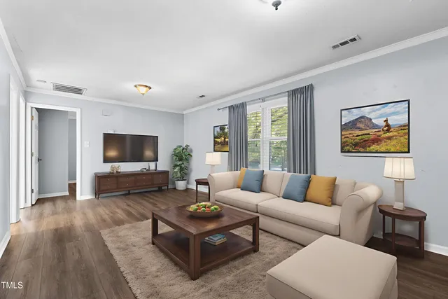 a living room with furniture a flat screen tv and a large window