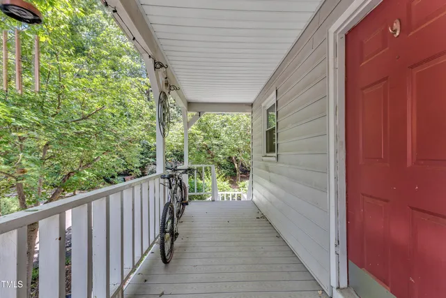 a view of hallway with wooden floor