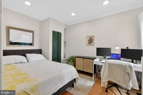 a bedroom with a bed and a desk