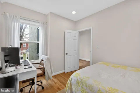 a bedroom with a workspace