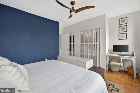 a bedroom with a bed and a desk