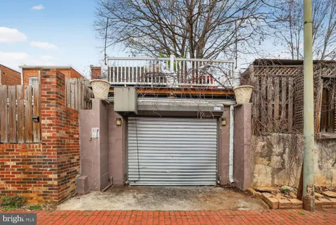 a view of a brick house with large windows