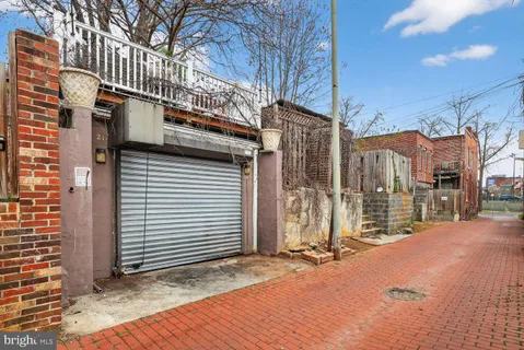 a view of a house with a door and wooden fence