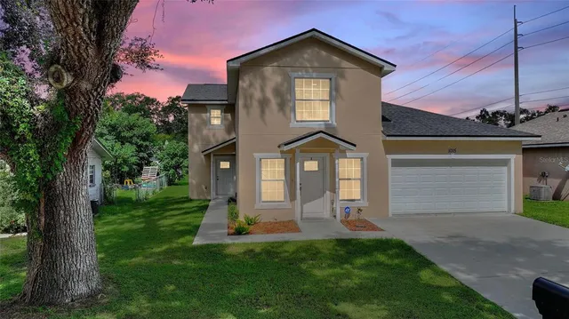 a front view of a house with a yard