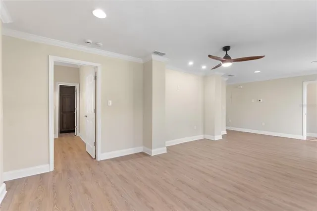 a view of an empty room with a ceiling fan