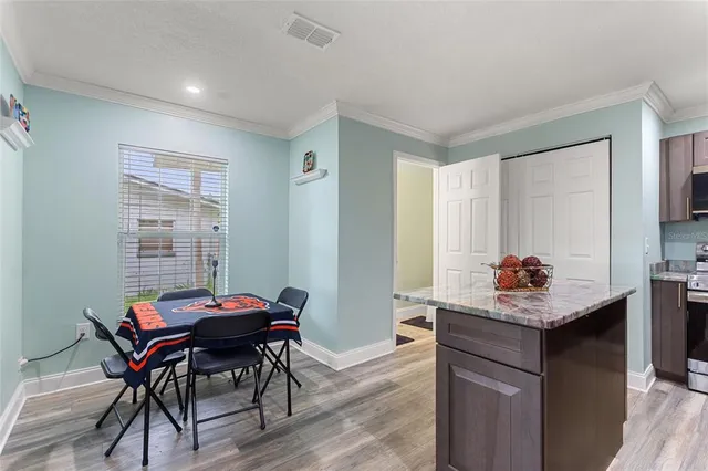 a kitchen with a table and chairs in it