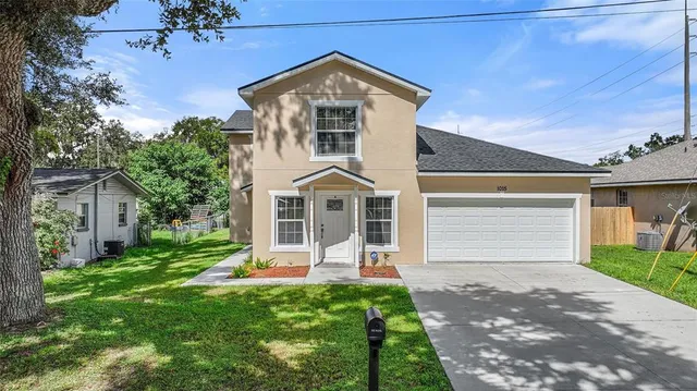 a front view of a house with a yard and garage