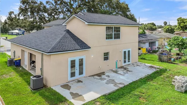 a view of a house with brick walls and a yard with plants