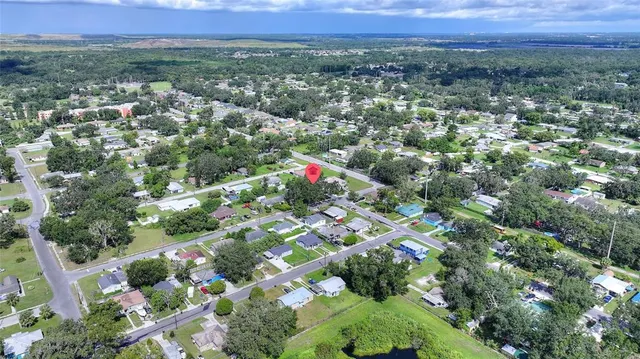 an aerial view of multiple houses with yard