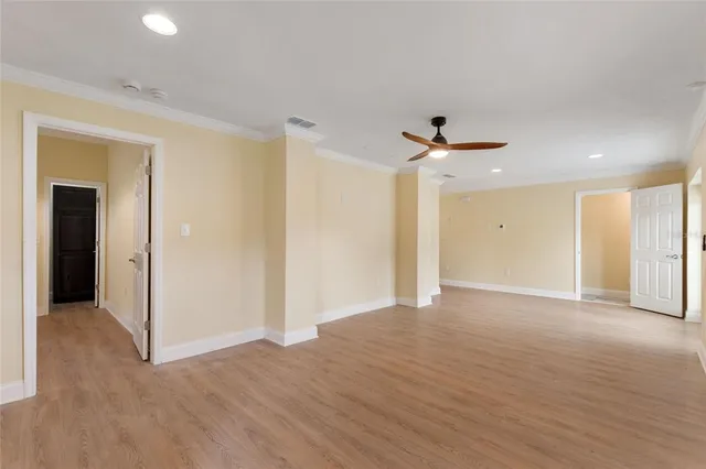 a view of an empty room with a ceiling fan