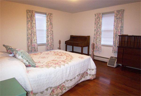 40 Donbray Road Springfield, MA 01119 - Photo 10 of 15 a bedroom with a bed and a dresser next to a window