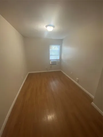 an empty room with a empty space and windows