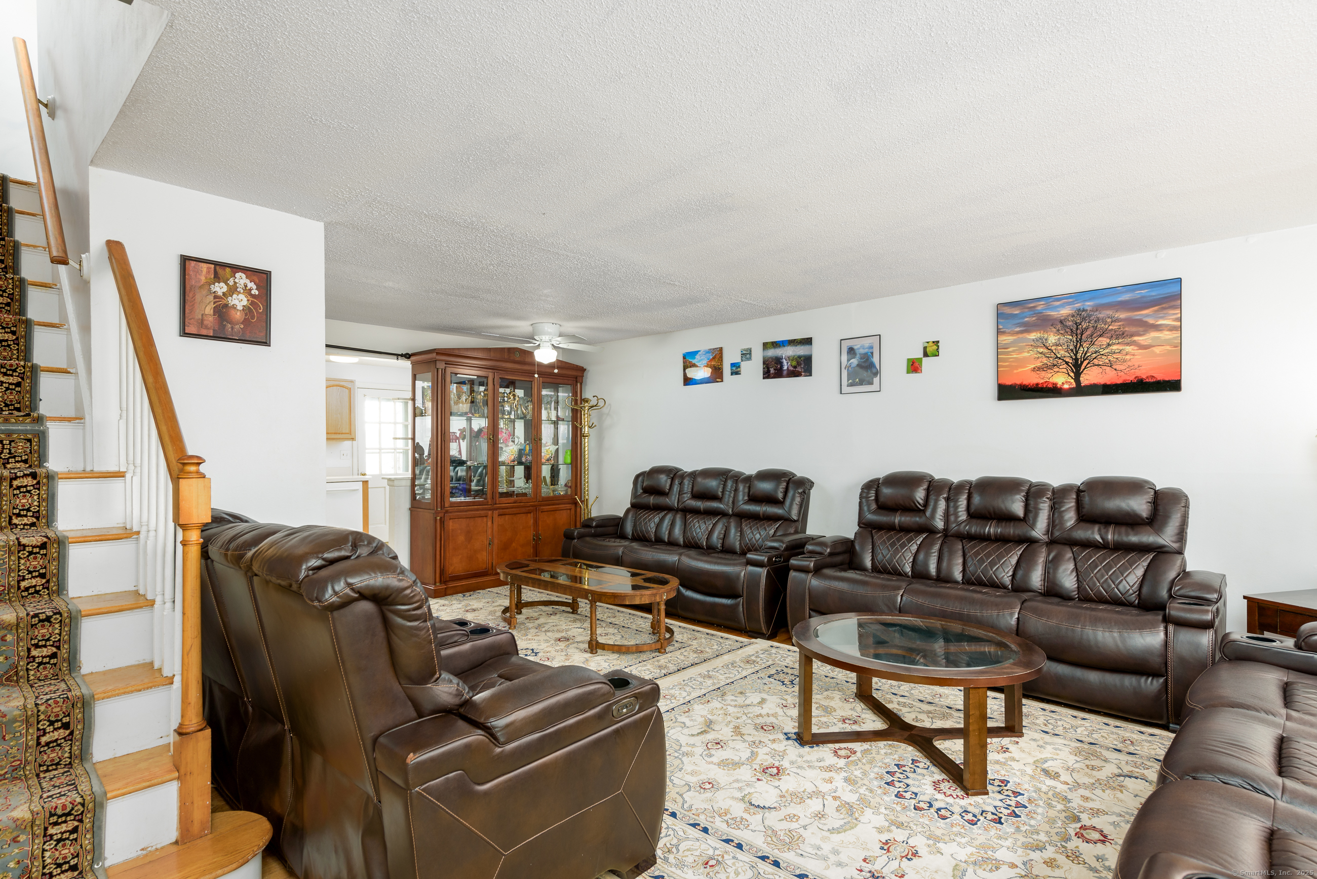 280 East Main Street, Unit E6 Clinton, CT 06413 - Photo 11 of 33 a living room with furniture ceiling fan and a rug
