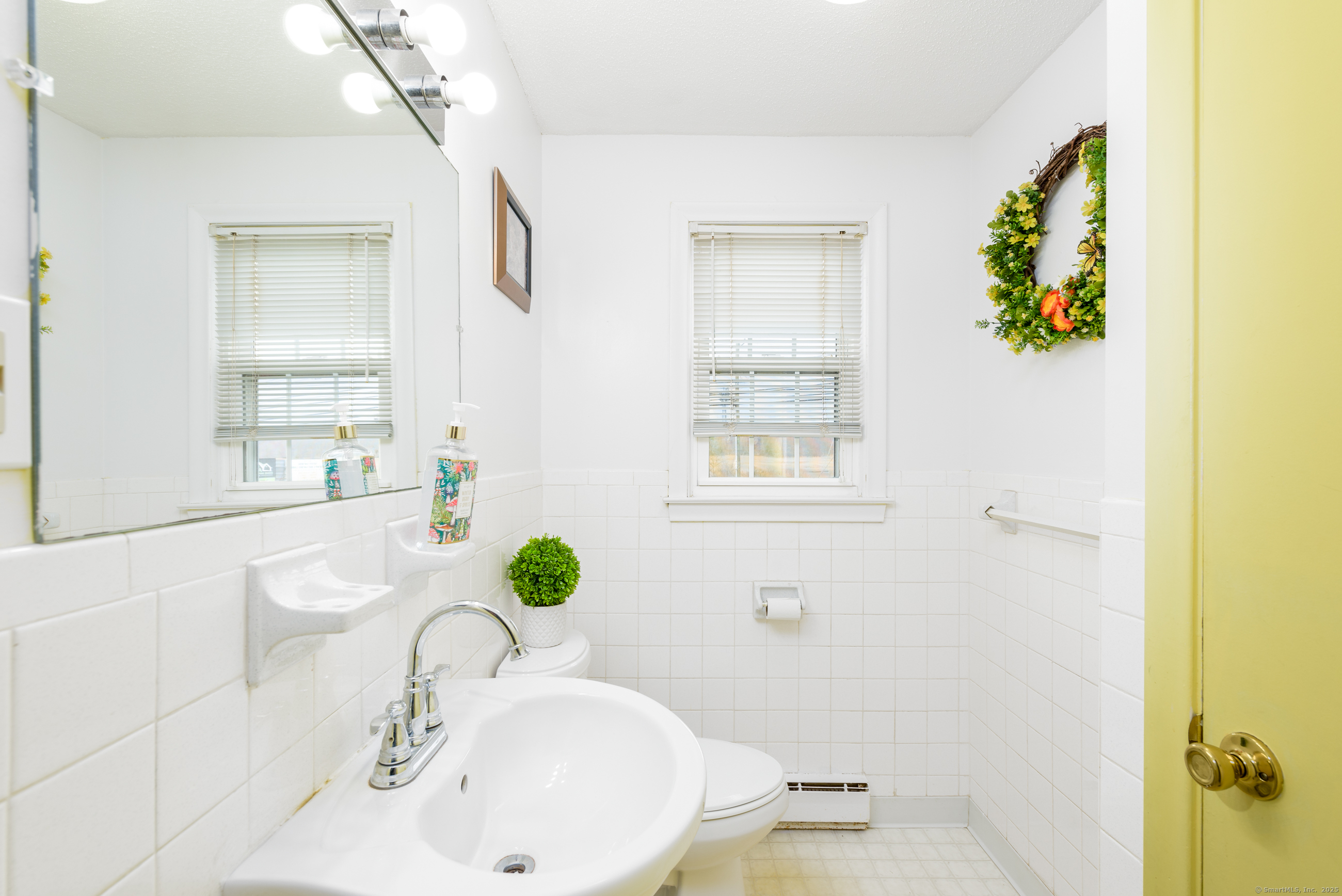 280 East Main Street, Unit E6 Clinton, CT 06413 - Photo 15 of 33 a bathroom with a sink mirror and vanity