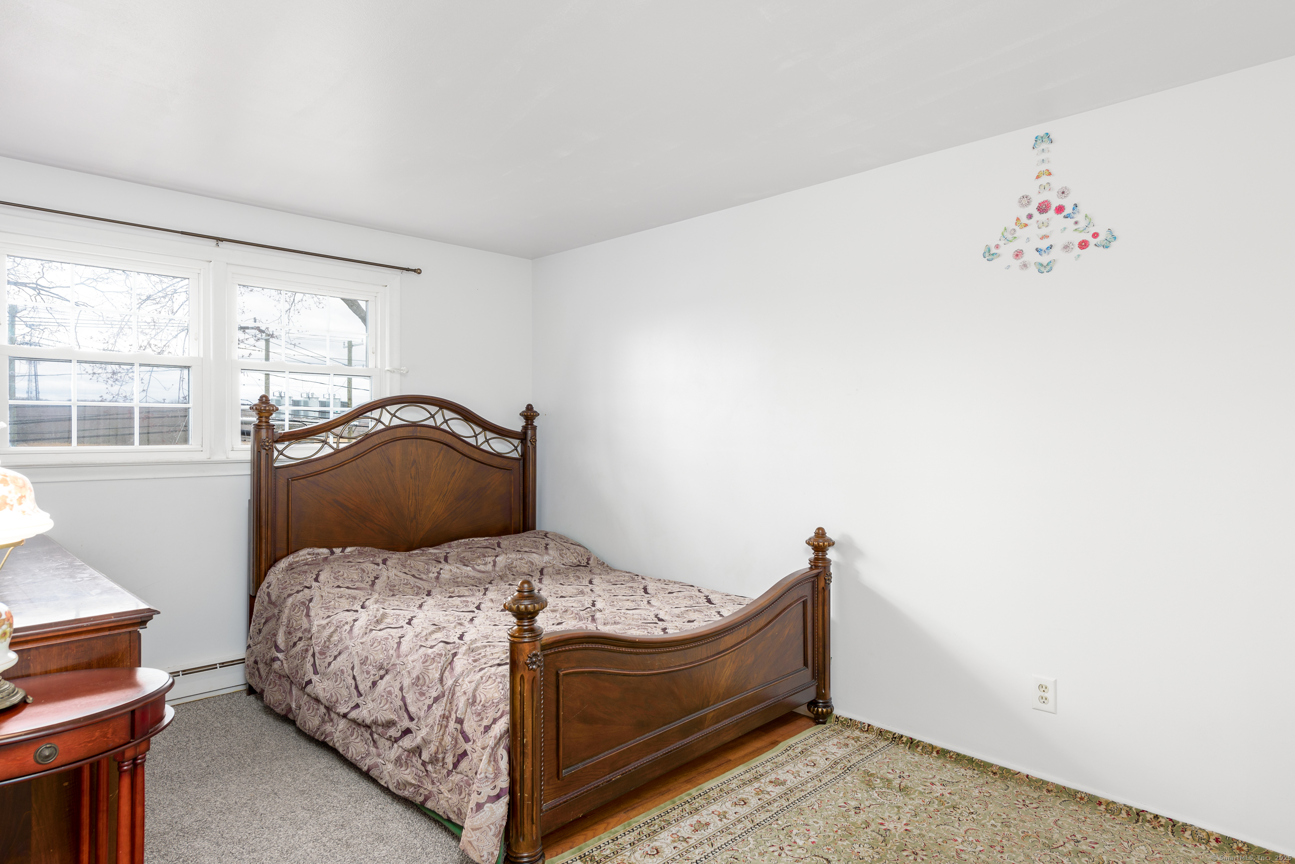280 East Main Street, Unit E6 Clinton, CT 06413 - Photo 17 of 33 a bedroom with a bed and wooden floor