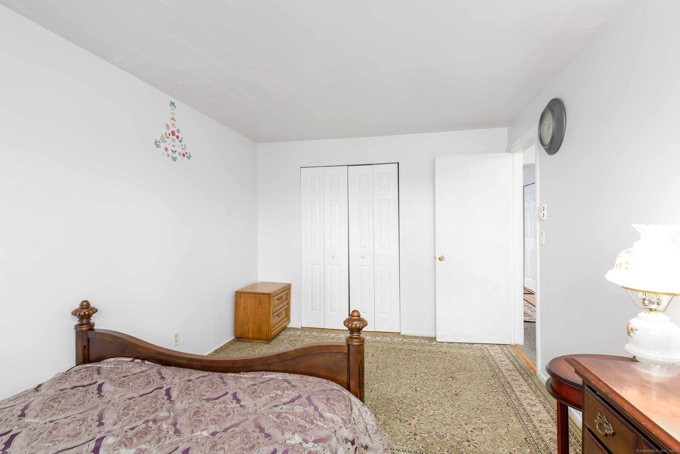 280 East Main Street, Unit E6 Clinton, CT 06413 - Photo 19 of 33 a bedroom with a bed and a lamp on dresser