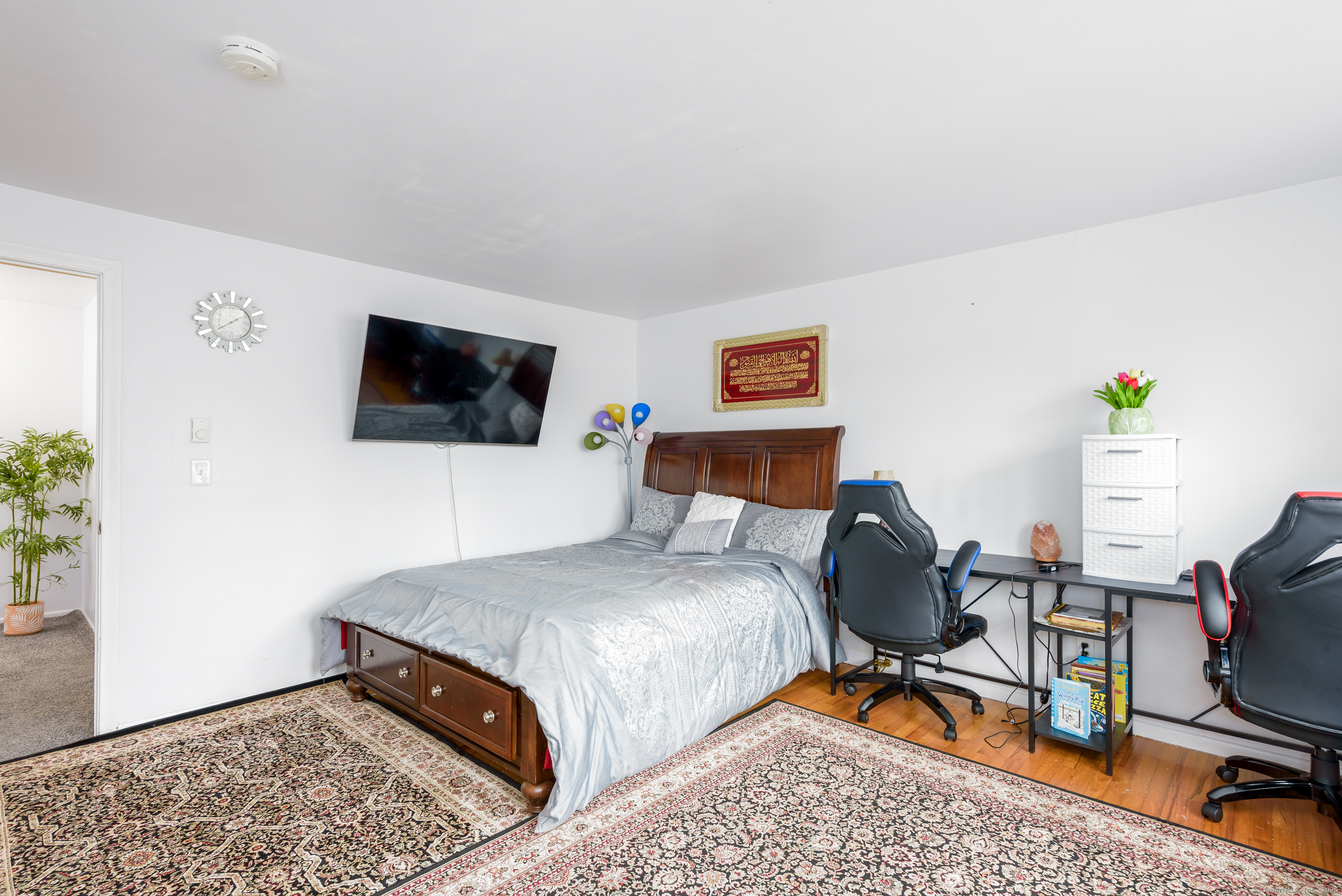 280 East Main Street, Unit E6 Clinton, CT 06413 - Photo 22 of 33 a bedroom with a bed and a flat screen tv