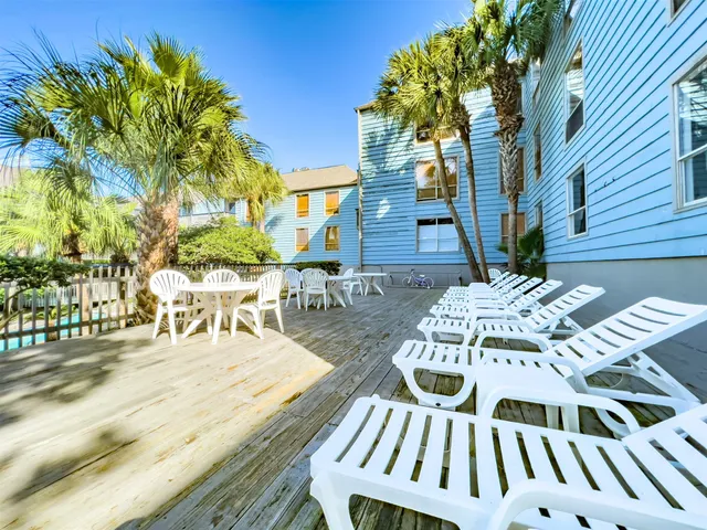 an aerial view of residential houses with outdoor space and ocean view