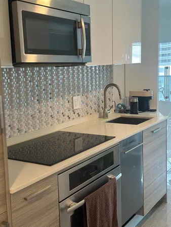 a kitchen with a stove microwave and sink