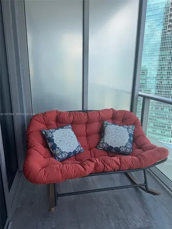 a blue bed sitting in a bedroom next to a window
