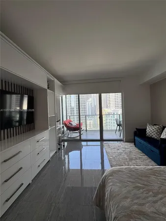 a spacious bedroom with a bed and large window