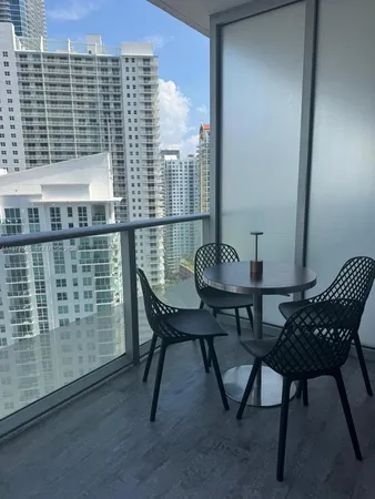 a view of a balcony with a table and chairs