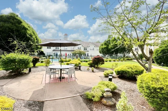 a view of a swimming pool with a patio and garden