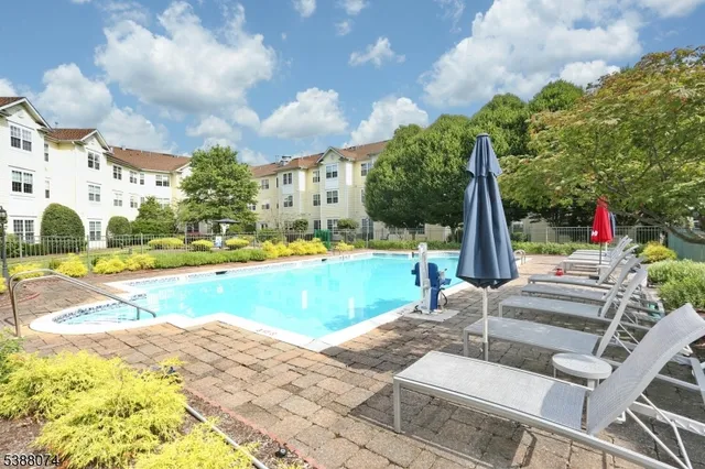 a view of swimming pool with sitting area and garden