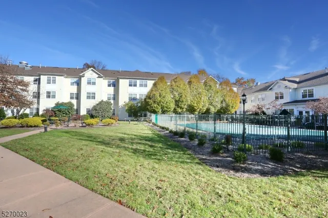 a view of a house with a yard and a fountain