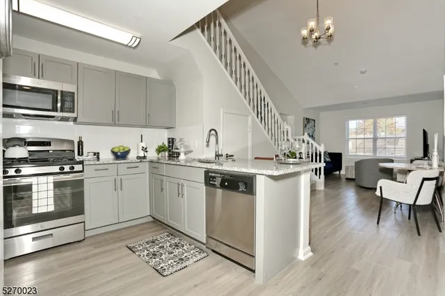 a kitchen with a stove and white cabinets