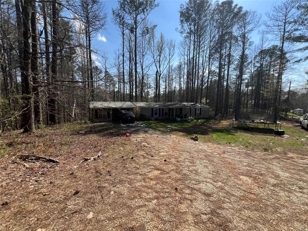 104 Cedar Lane Buchanan, GA 30113 - Photo 2 of 3 a view of a backyard with large trees