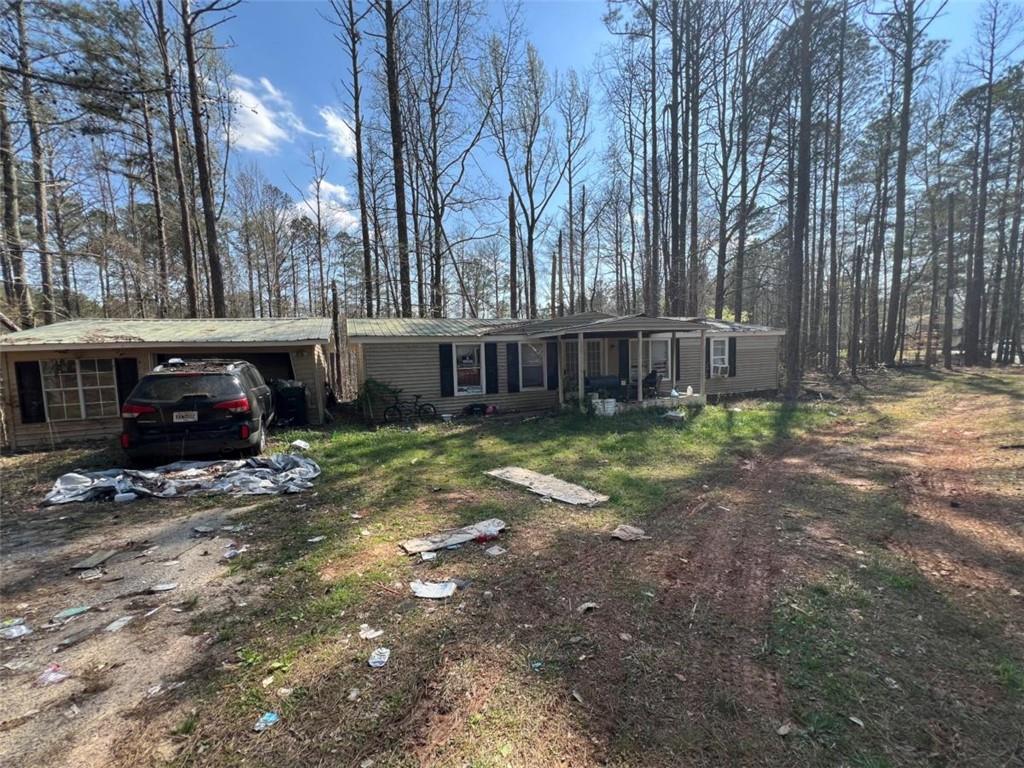 104 Cedar Lane Buchanan, GA 30113 - Photo 3 of 3 a view of a house with a yard and trees