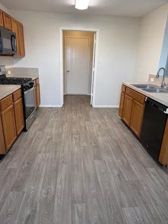 a view of a kitchen from the hallway